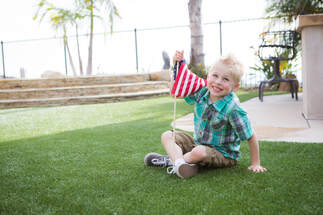 Kid with American Flag in The Woodlands, Texas on NextLawn artificial grass